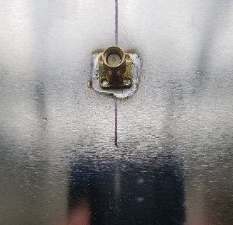 The SMA feedthrough soldered to the can.